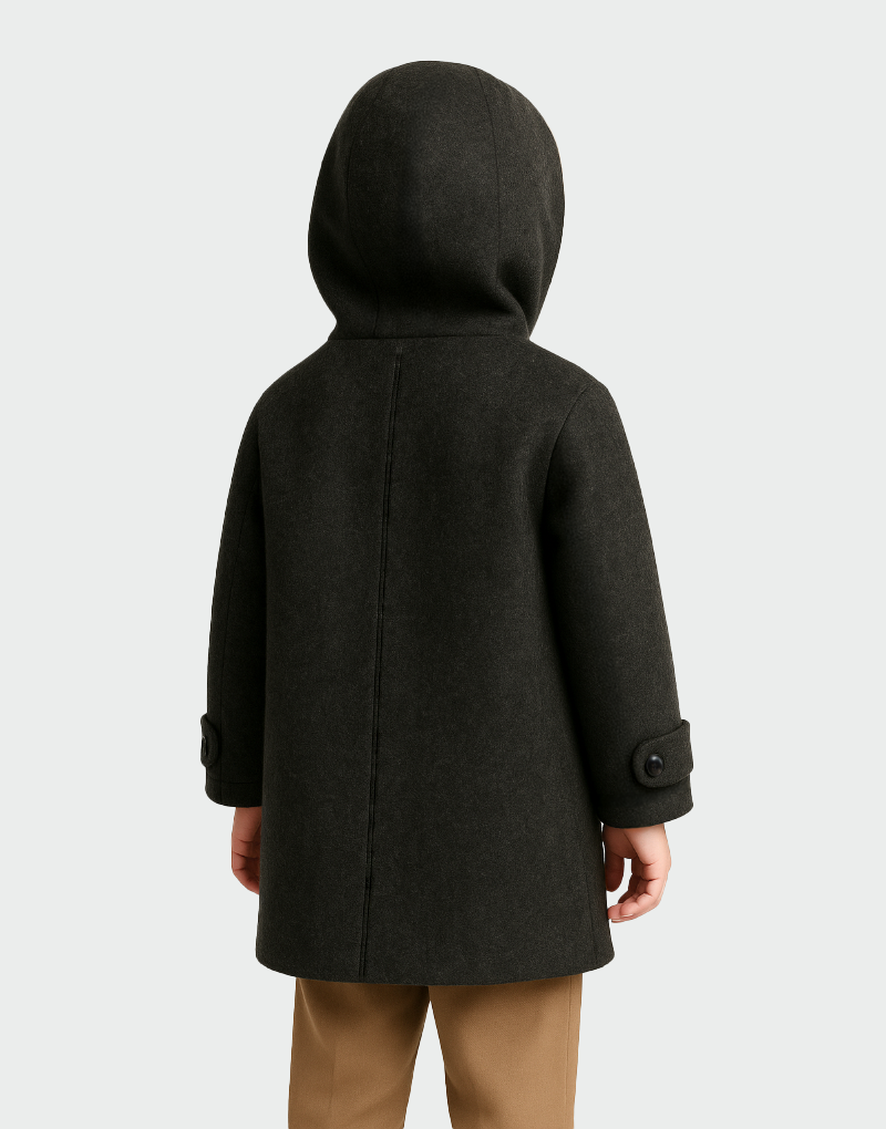 Vista trasera de niño con abrigo oscuro de lana baby alpaca con capucha y detalle de botones en las mangas